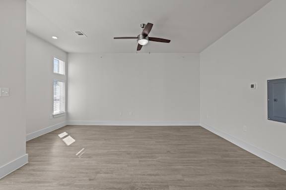 A room with a ceiling fan and a window.