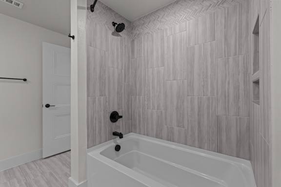 A white bathroom with a tub and a shower.