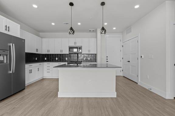 A modern kitchen with a large island in the center.