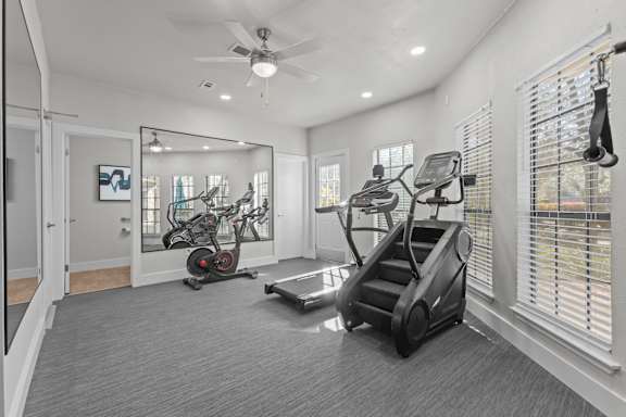 A spacious home gym with a variety of exercise equipment.
