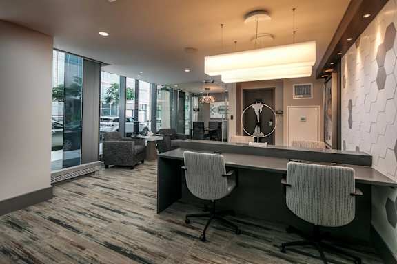 A modern office with a long table and chairs.