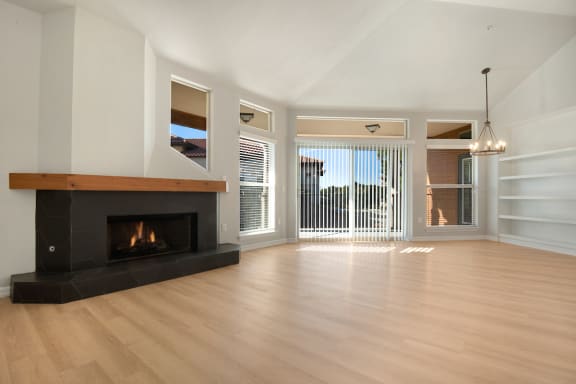 a living room with a fireplace and hardwood floors