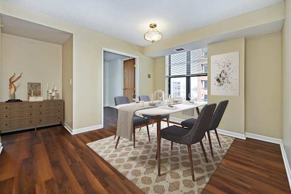 A dining room with a table and chairs.