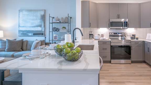 A modern kitchen with a dining table set for four.