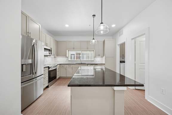 A modern kitchen with a large island in the center.