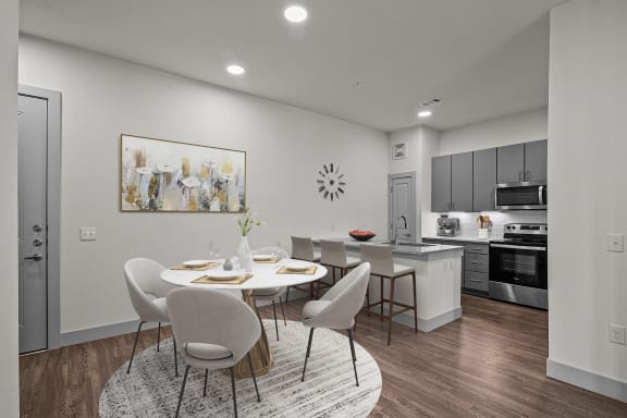 an open kitchen and dining room with a table and chairs
