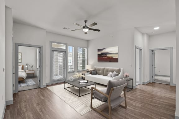 a living room with a couch and a ceiling fan
