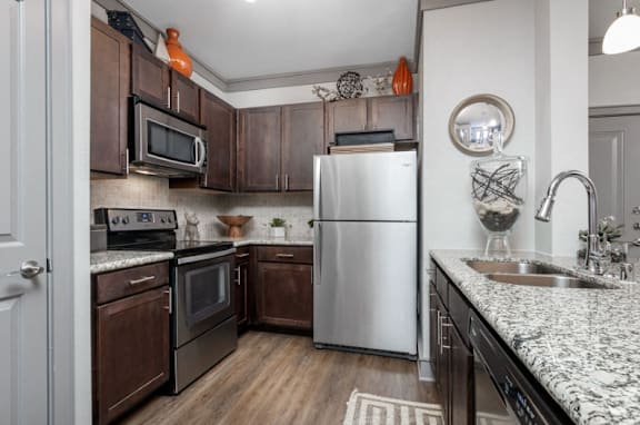 A kitchen with a white refrigerator and wooden cabinets.