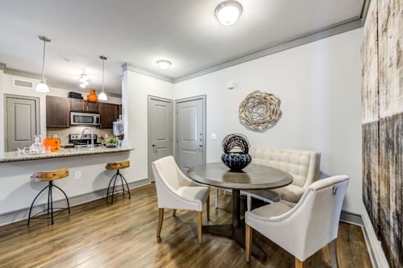 A modern kitchen with a dining table and chairs.