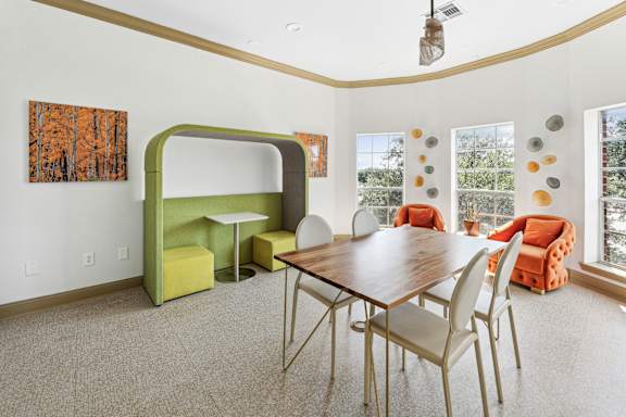 A dining room with a wooden table and chairs.