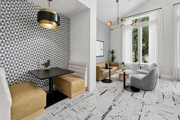 A modern dining area with a black table and chairs.
