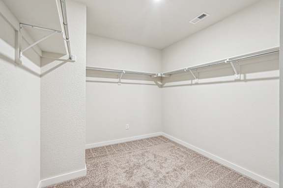 A white room with a carpeted floor and white walls.