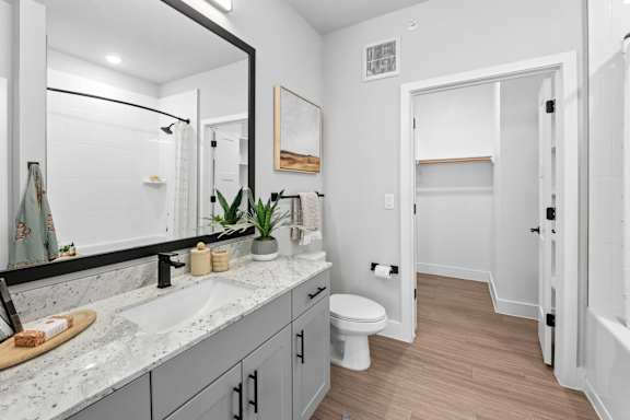 A bathroom with a white toilet and a sink.