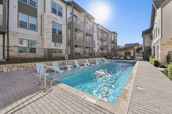 A sunny day at the poolside of apartment buildings.