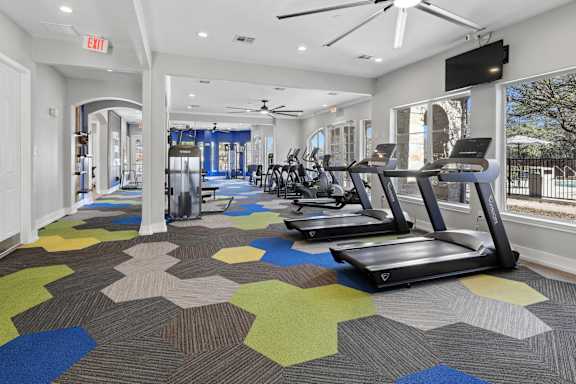 A gym with treadmills and exercise equipment.