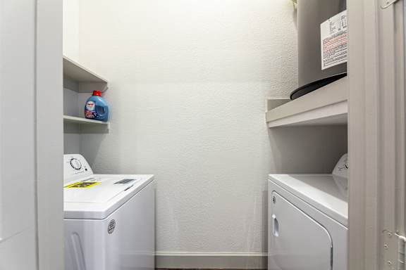 A small laundry room with a washer and dryer.