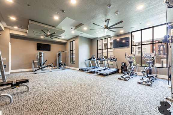 A spacious home gym with a variety of exercise equipment.