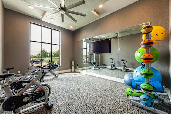 A room with exercise equipment and a television.
