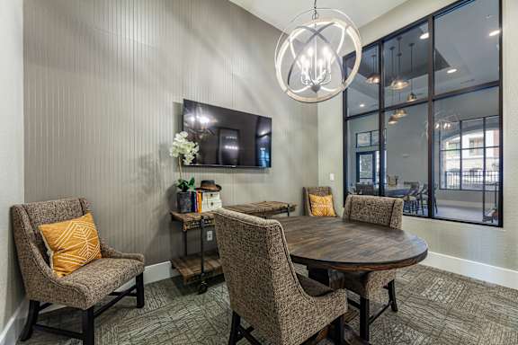 A modern dining room with a wooden table and chairs.