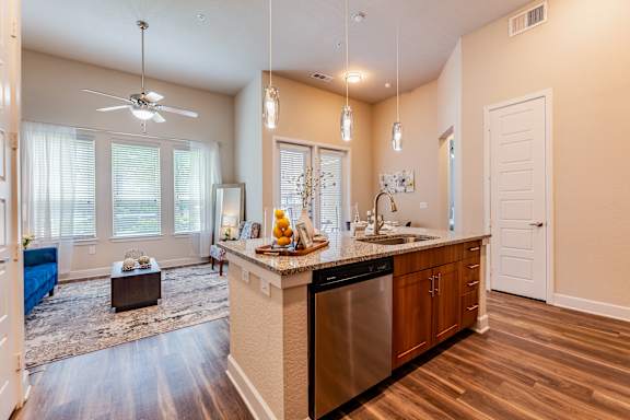 A kitchen with a large island and a fan.