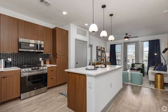 A modern kitchen with wooden cabinets and a white island.