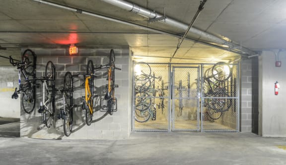 a parking garage with bikes hanging on the wall