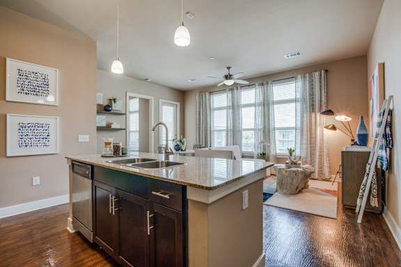 A kitchen with a sink and a counter.