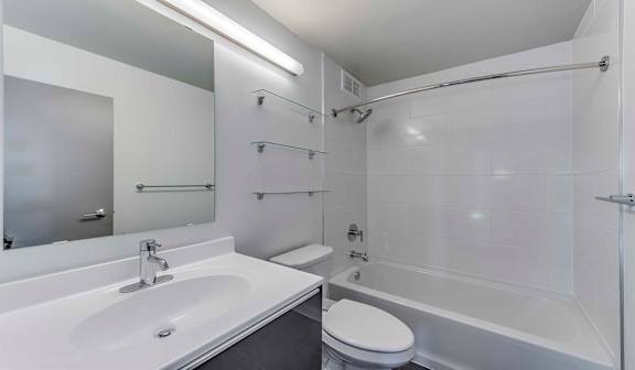 A white sink and toilet in a modern bathroom.