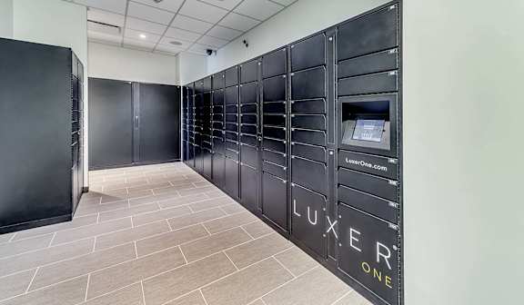 A row of black lockers with the word "LUXER" written on them.