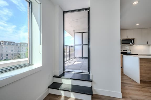 a kitchen with a large window and a glass door