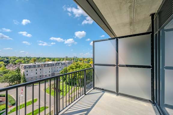 a balcony with a view of a building and trees
