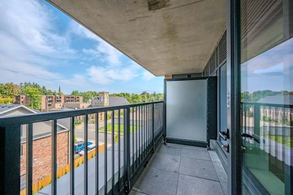 a balcony with a view of a building and a river
