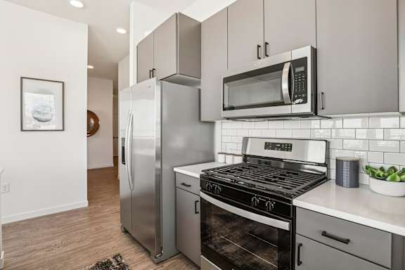A modern kitchen with stainless steel appliances and a white countertop. at Lura Vegas Apartments, Las Vegas, Nevada