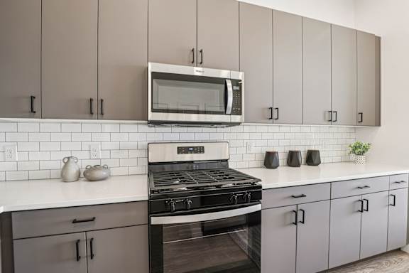 A modern kitchen with a stove, oven, and microwave. at Lura Vegas Apartments, Las Vegas