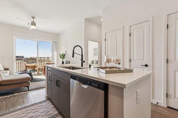 A modern kitchen with a large island and stainless steel appliances. at Lura Vegas Apartments, Las Vegas, 89103