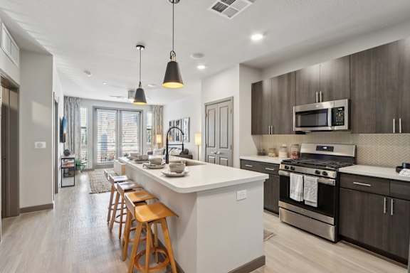 Kitchen Island With Pendent Lights at The Rey Downtown Apartments, Phoenix, AZ, 85003