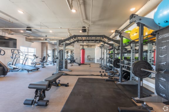 a gym with cardio equipment and weights on the floor at Aura Vegas Apartments, Las Vegas, 89103