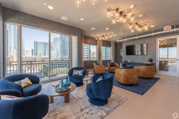 a living room with couches and chairs and a television at Aura Vegas Apartments, Nevada, 89103