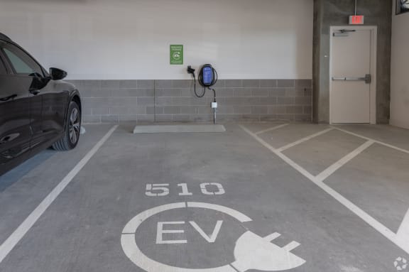 a parking garage with a car and a gas pump at Aura Vegas Apartments, Las Vegas, Nevada