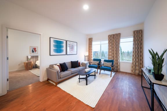 a living room with a couch and two chairs at Hana Apartments, Hillsboro, OR
