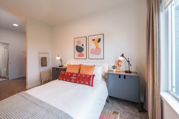 a bedroom with a bed and two night stands at Hana Apartments, Hillsboro, OR 97006
