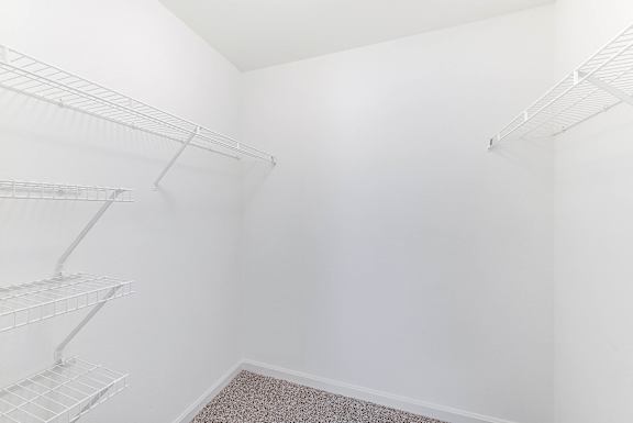 Empty walk-in closet with white walls and shelves at Acclaim at Sterling in Sterling, 20164