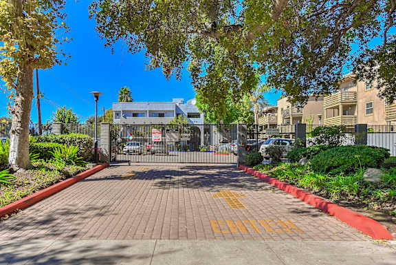 A gated entrance with the word "ENTER" painted on the pavement.