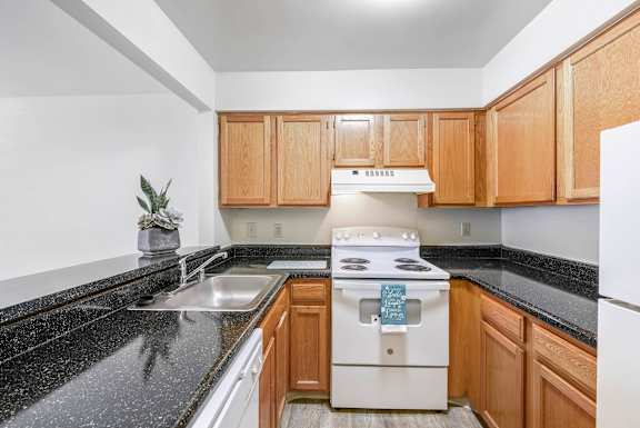 Kitchen with wooden cabinets at Vistas at Lake Largo 55+ Senior Community, Largo, Maryland
