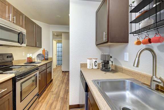 A kitchen with a stove, microwave, and oven.