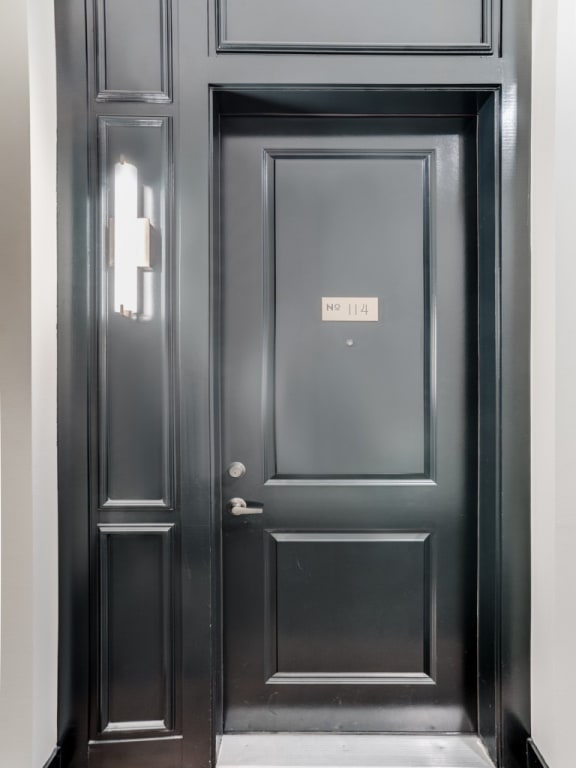 a black door with a door tag on it