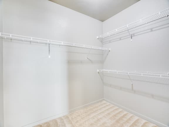 our spacious walk in closets are equipped with shelves and hooks for hanging clothes
