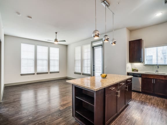 an empty kitchen with a large island in the middle of it