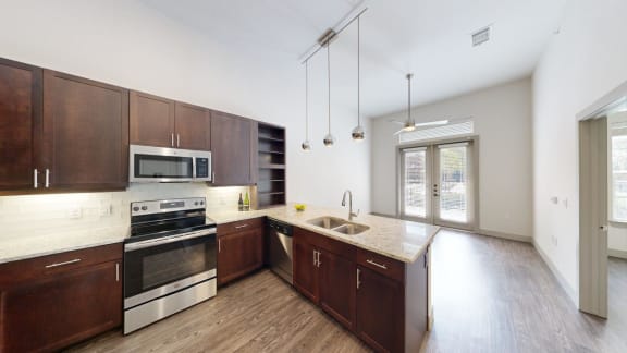 a large kitchen with wooden cabinets and stainless steel appliances