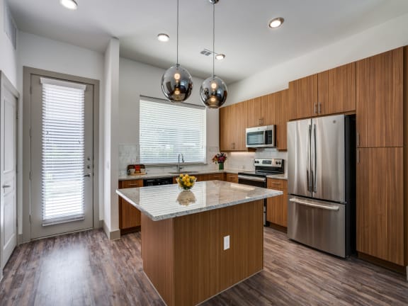 a kitchen with wooden cabinets and stainless steel appliances